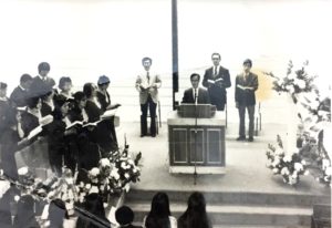 Church service inside the Gospel Church, with Rev. Ho preaching, me on the left, and Eddie Mak on the right.